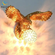 Modern golden eagle crystal led wall lamp with detailed feathered wings and patterned glass globe for bedroom living room