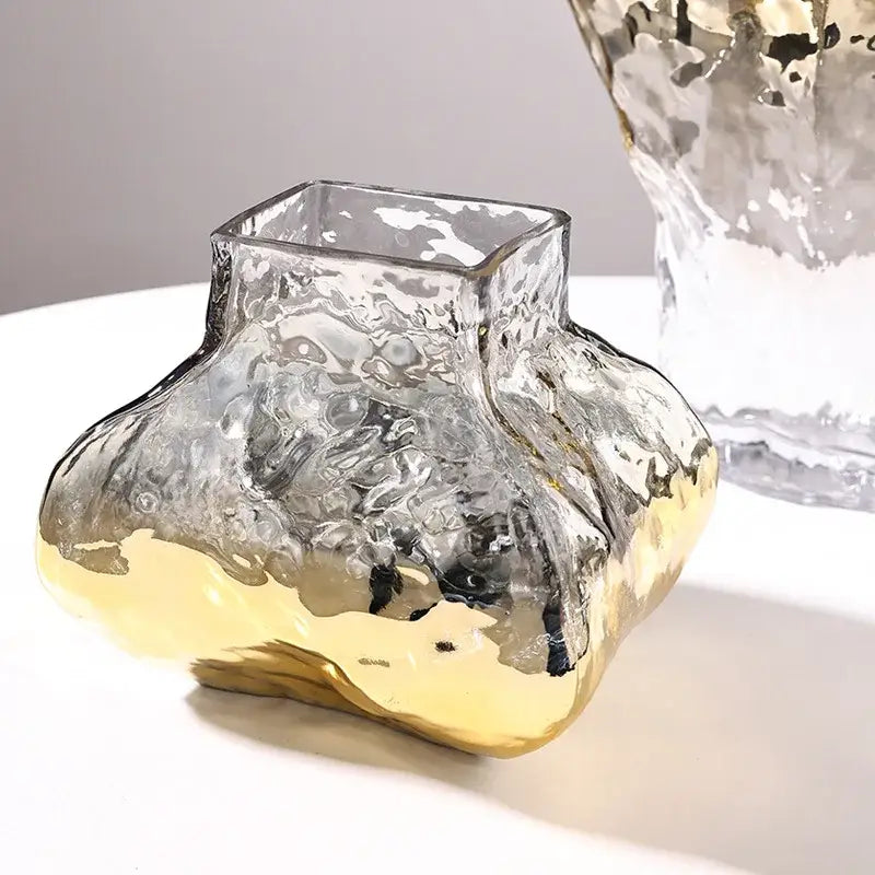 Translucent glass vase with a textured hammered surface and golden geometric metallic base for decorbites golden geometric decor