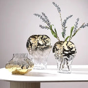 Three modern golden geometric glass vases with hammered metallic finish gold and black accents on clear bases for decorbites golden geometric decor