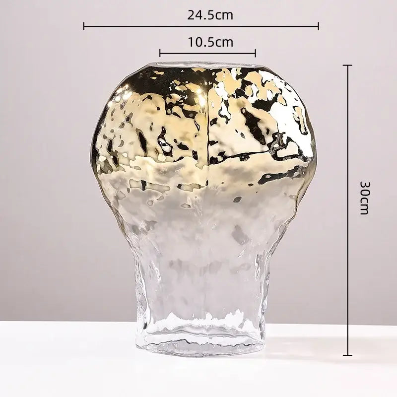 A tall modern golden geometric glass vase with a metallic gold and black marbled top and clear bottom for decorbites decor