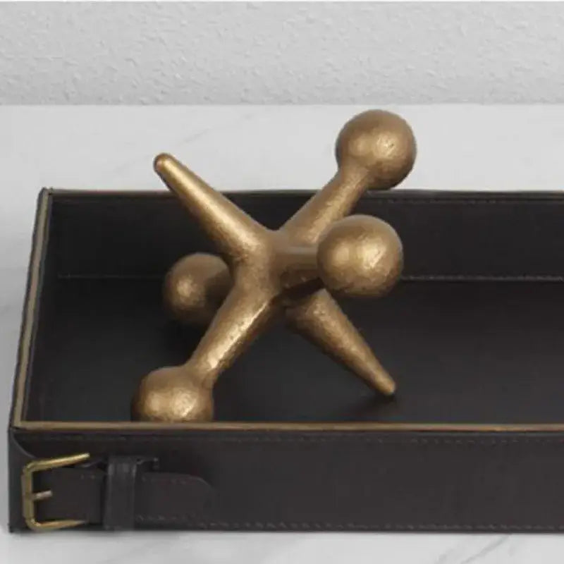 Modern golden geometric resin molecular model decor featuring a golden metallic star with rounded ends and textured finish
