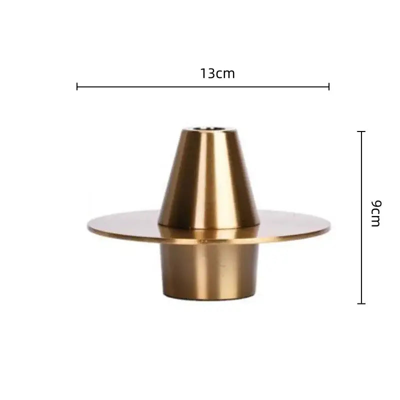 A sleek gold-toned geometry metal handicraft candle holder with conical top and circular base for decorbites golden geometry decor