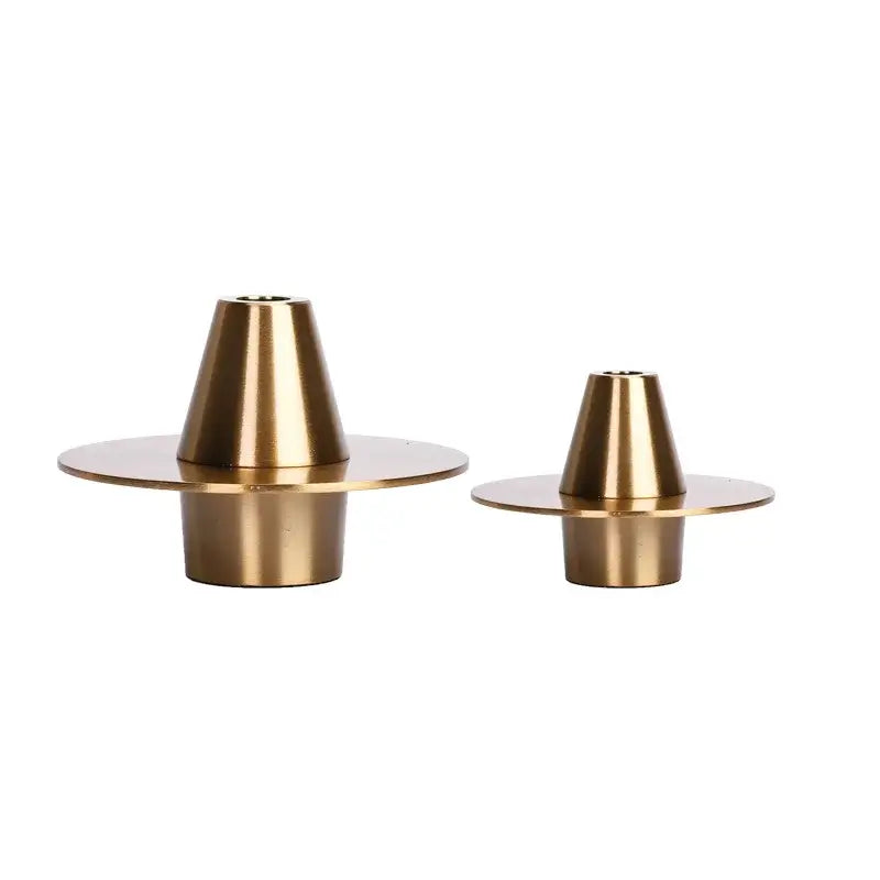 Two elegant brass candle holders with conical design and circular bases for decorbites golden geometry metal decor