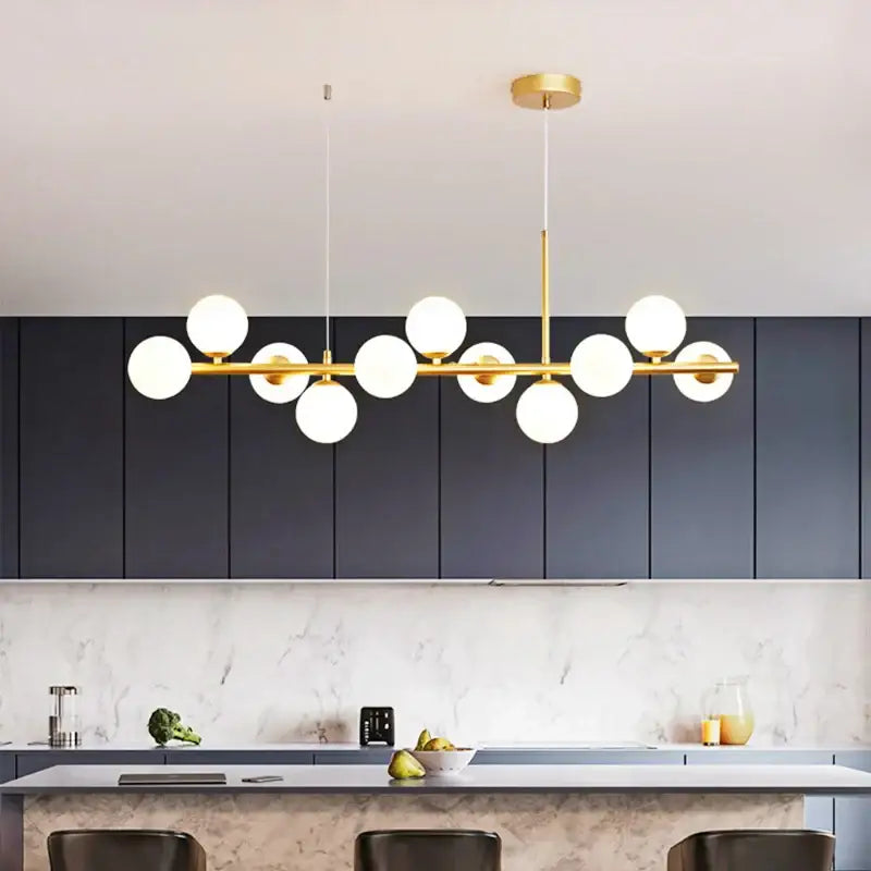 Modern golden glass ball chandelier featuring gold-toned metal and white spherical globes for dining room decorbites golden glass