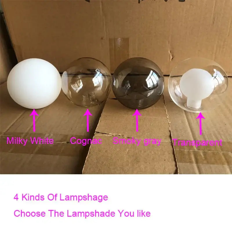 Modern golden glass ball chandelier with milky white cognac smoky gray and transparent glass ball shades on cardboard surface