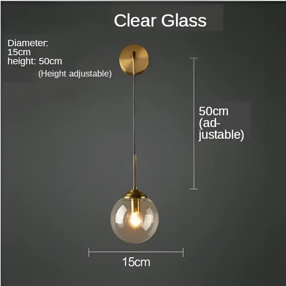 A sleek modern golden glass ball wall sconce with clear glass globe and brass-finished hardware by decorbites golden glass