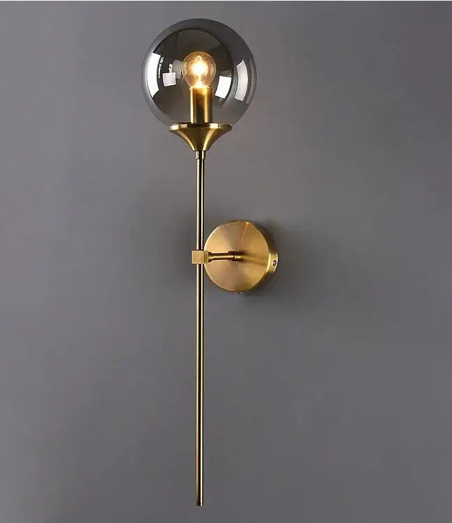 A sleek modern golden glass ball wall sconce with brass finish and smoked glass globe for living room decorbites lighting