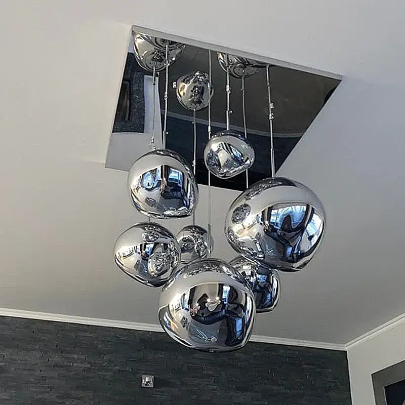 Modern chrome-finished spherical pendant lights with reflective globes suspended from square fixture for decorbites glass lava decor