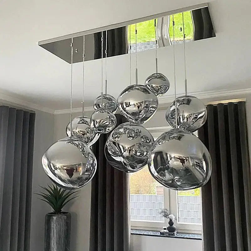 Modern chrome-finished spherical pendant light with reflective surfaces and sleek mount for decorbites glass lava pendant lights