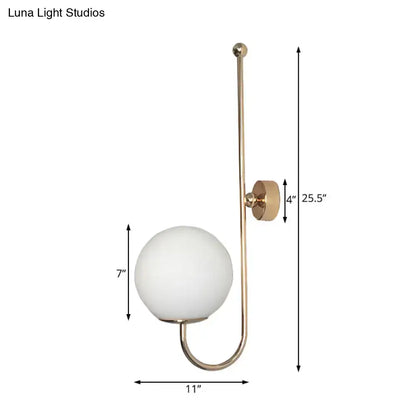 Modern golden gooseneck wall sconce with frosted glass ball shade and minimalist curved metal arm for bedroom use