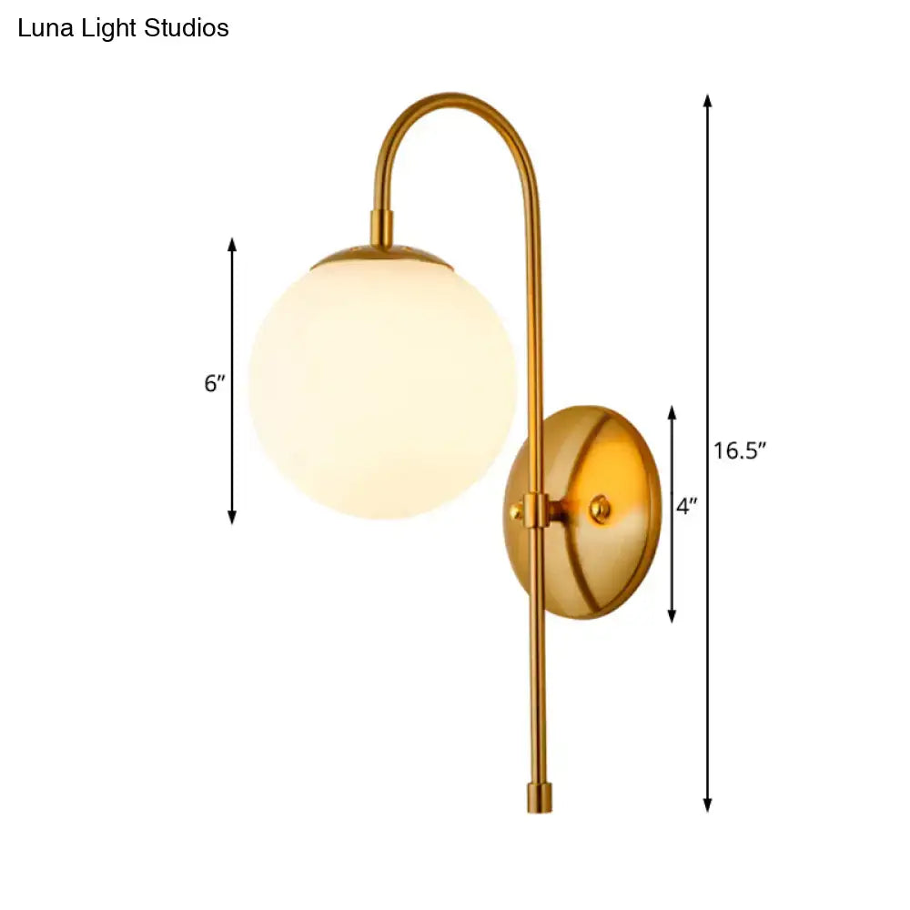 Modern golden gooseneck wall sconce with frosted glass ball shade and curved arm for bedroom lighting