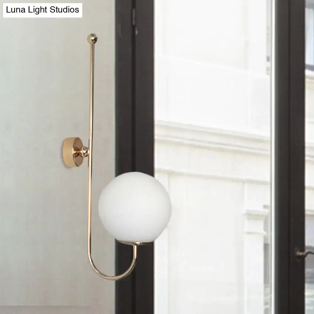 Modern golden gooseneck wall sconce with frosted glass ball shade for bedroom lighting