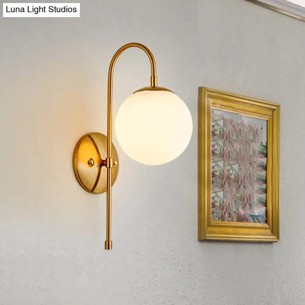 Modern golden gooseneck wall sconce with frosted glass ball shade and curved arm for bedroom lighting