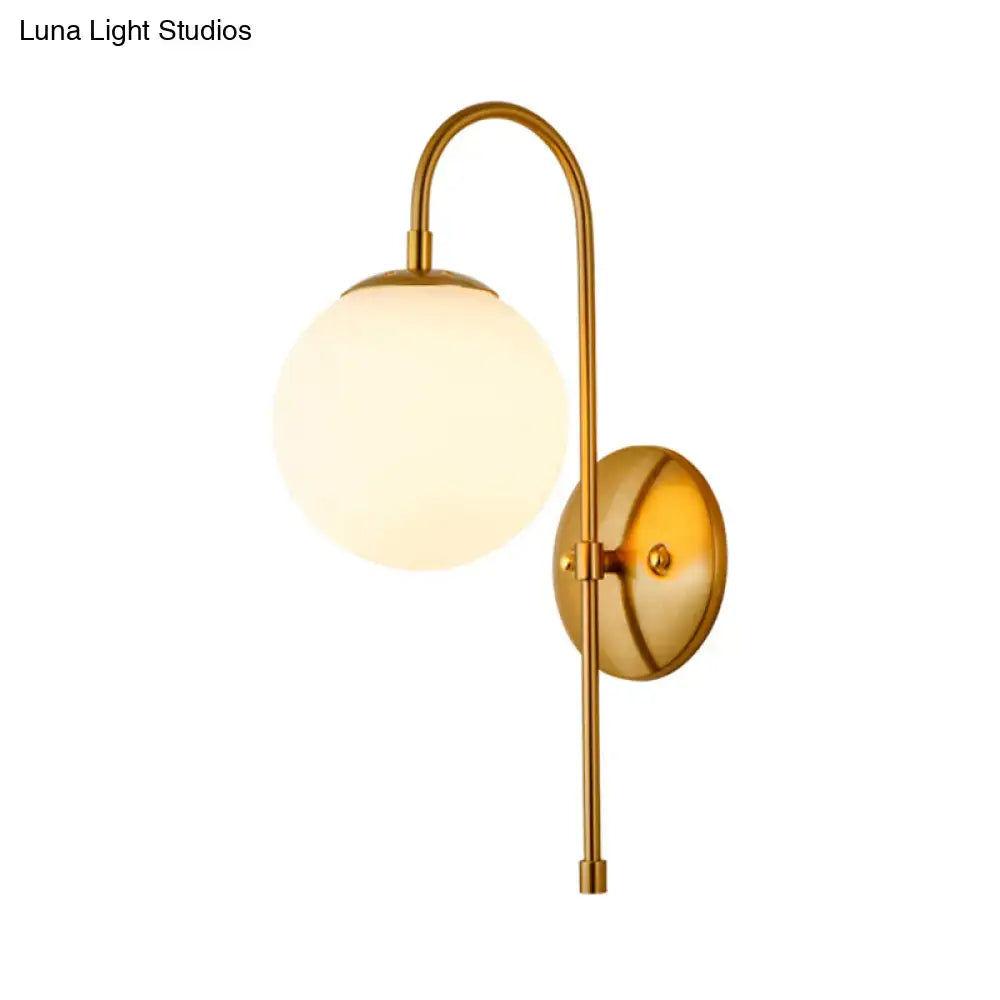 Modern golden gooseneck wall sconce with frosted glass ball shade and curved arm for bedroom lighting