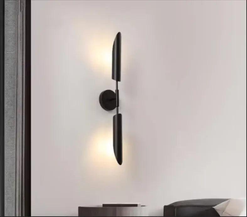 Black matte-finished modern golden inclined tube wall lamp with two vertical cylindrical shades for living room decorbites golden inclined