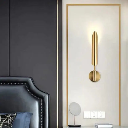 Modern golden inclined tube wall lamp with a sleek gold-toned cylindrical design and circular base for living room decorbites