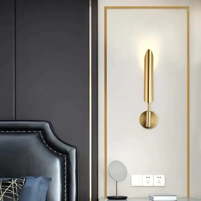 Modern golden inclined tube wall lamp with a sleek gold-toned cylindrical design and circular base for living room decorbites