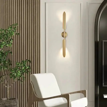 Modern golden inclined tube wall lamp with gold-toned minimalist vertical bars and central circular accent for living room decorbites golden inclined