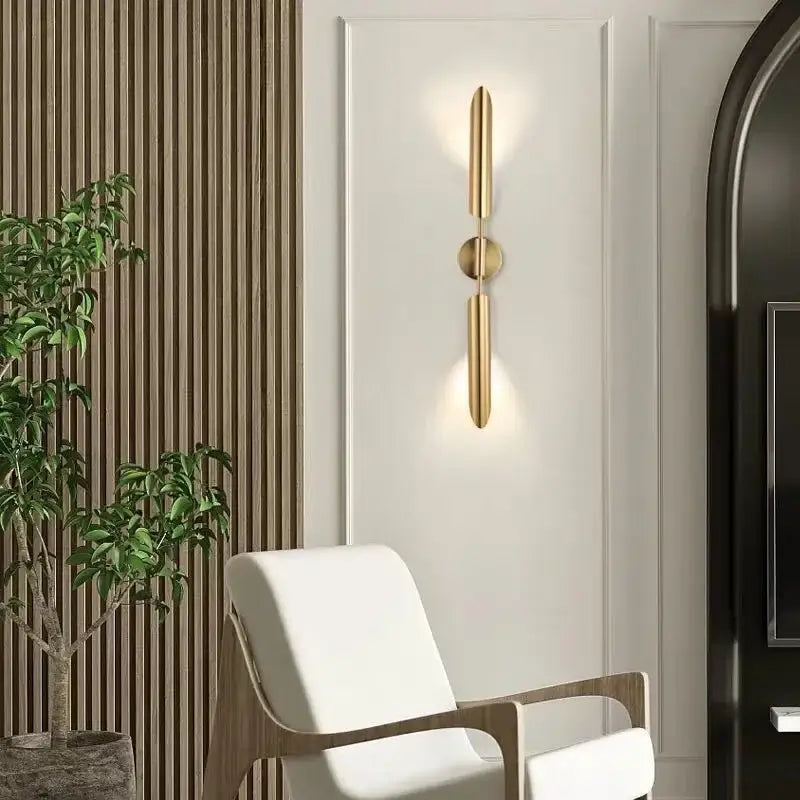 Modern golden inclined tube wall lamp with gold-toned minimalist vertical bars and central circular accent for living room decorbites golden inclined