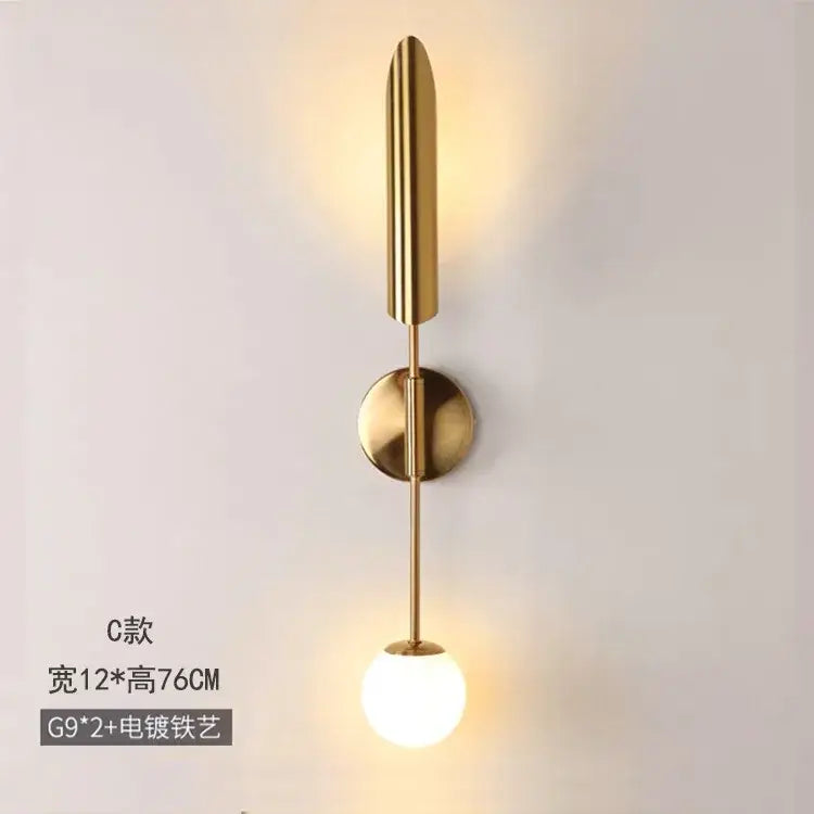 Modern golden inclined tube wall light with gold-toned stem and frosted glass bulb for stylish living room decorbites golden inclined