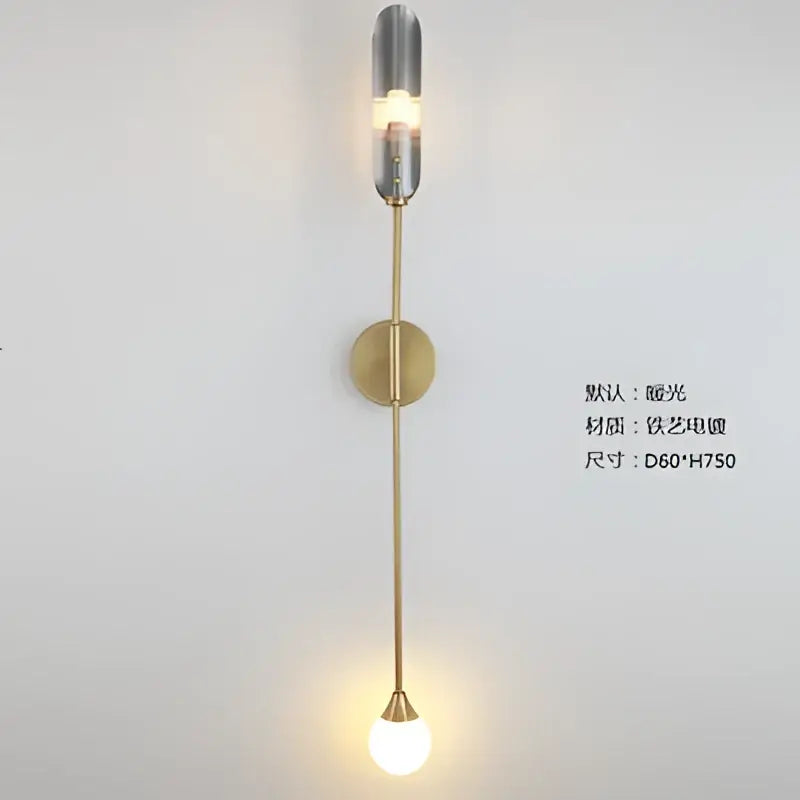 A modern golden inclined tube wall light with a brass finish and frosted glass shade for living room decorbites