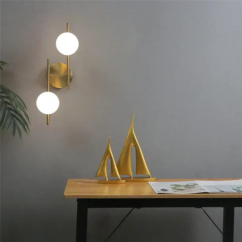 Modern golden indoor wall lights featuring a gold minimalist sconce with two frosted glass spheres for bedroom decorbites golden indoor use