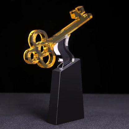 Modern golden key crystal trophy with a golden acrylic key and transparent black base for living room decorbites crystal trophy decor