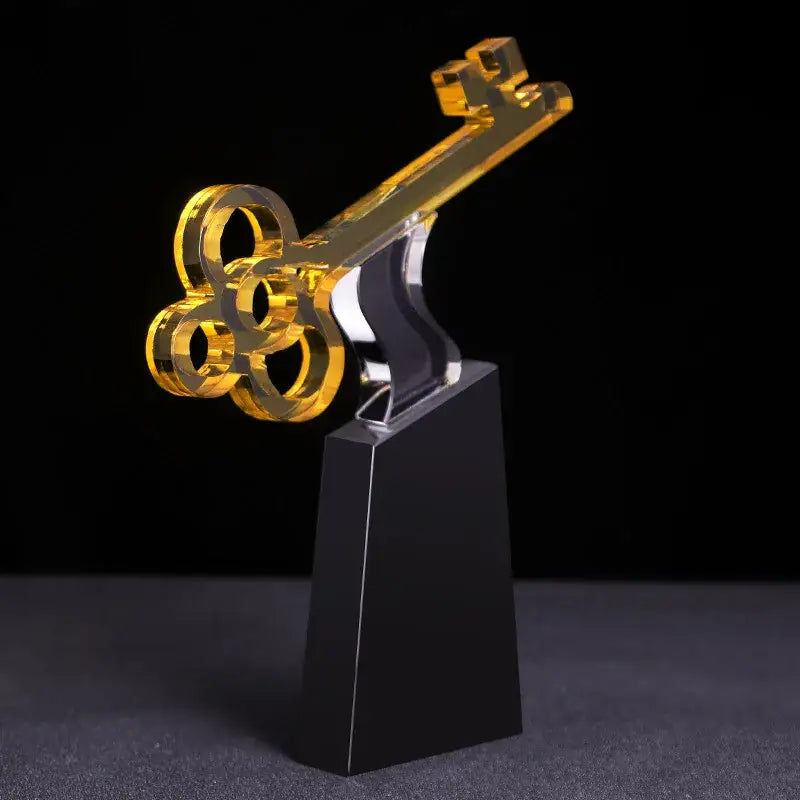 Modern golden key crystal trophy with a golden acrylic key and transparent black base for living room decorbites crystal trophy decor
