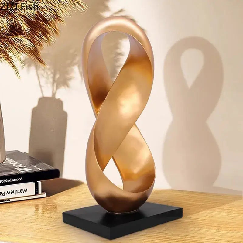 Modern golden knot sculpture with polished metallic infinity design on black base ideal as knot sculpture desk decorbites accessory
