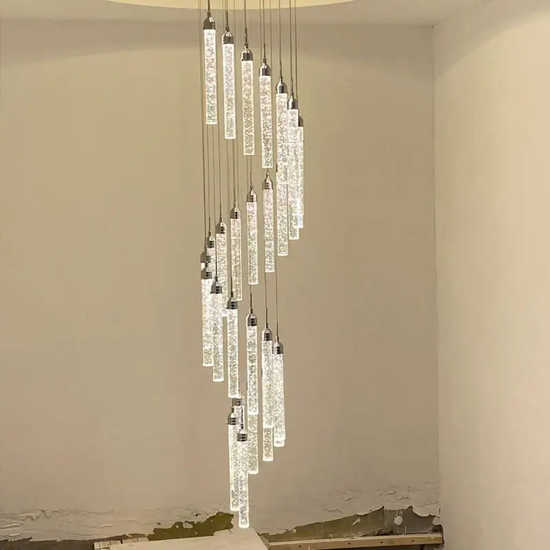 A modern decorbites golden led crystal chandelier with cascading glass tubes and sparkling elements for living rooms