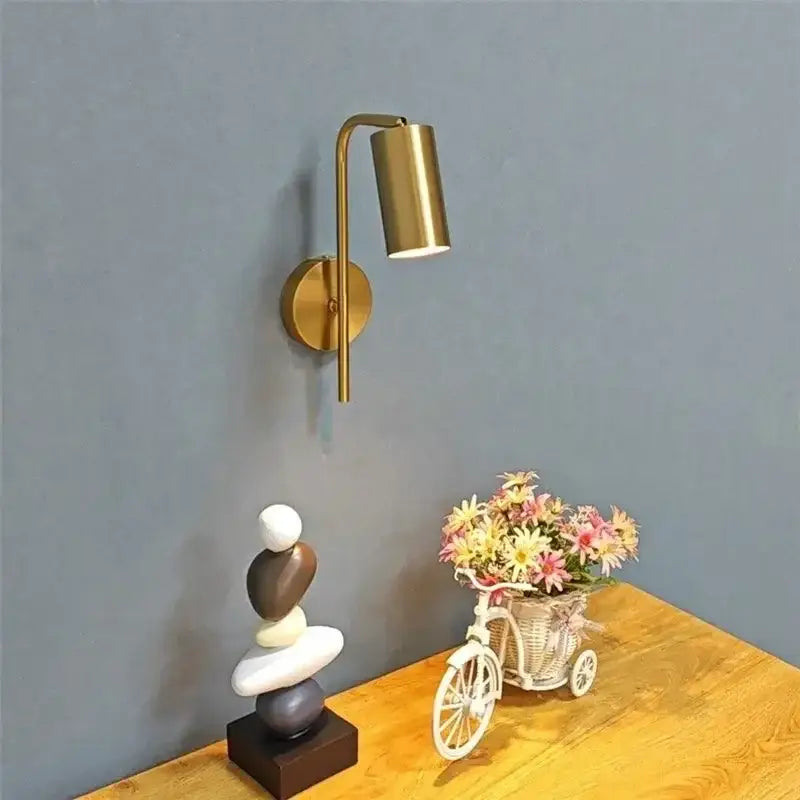 Brass-finished wall lamp with curved arm and cylindrical lamp head modern golden led reading for bedroom decorbites golden led