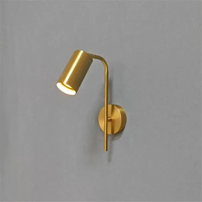 Modern golden led reading wall lamp with gold-finished curved arm and cylindrical spotlight for minimalist decorbites decor