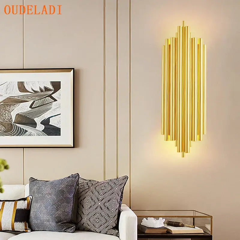Modern golden led tube wall sconce with gold-toned vertical cylindrical rods for living room decor by decorbites