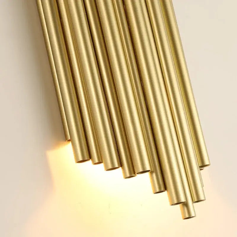 Modern golden led tube wall sconce with slender brass tubes in a diagonal fan design for living room decorbites decor