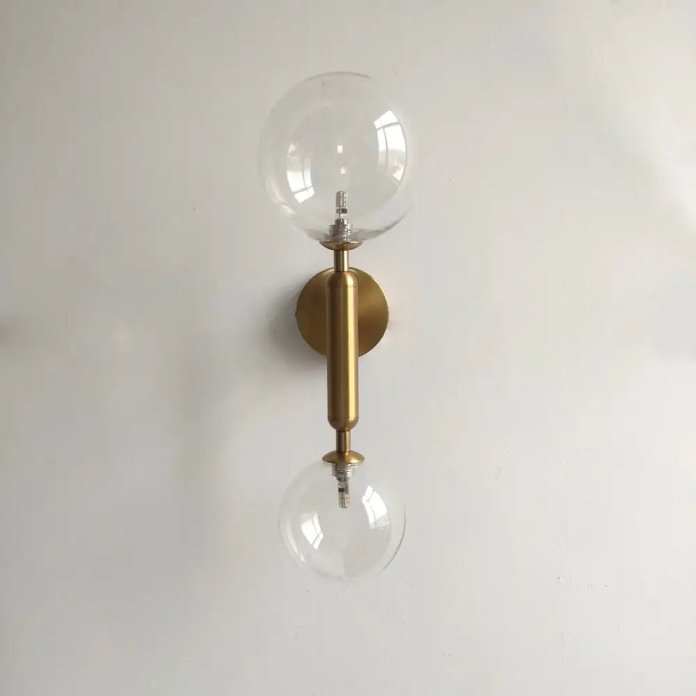 Modern golden led wall sconce with brass finish and two clear glass globe bulbs for bedroom decorbites golden led wall