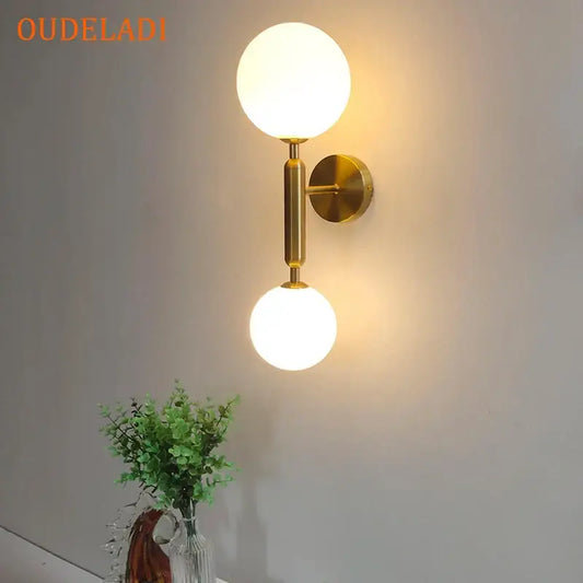 Modern golden led wall sconce with milky glass globes featuring two spherical frosted globes for bedroom decorbites golden led wall