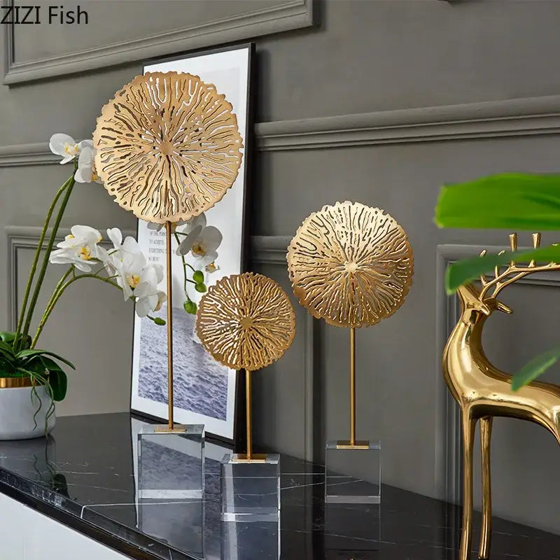 Modern golden lotus sculpture featuring gold-colored intricately cut metal lotus sculptures on clear acrylic bases