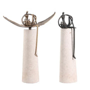 Two golden metal abstract figure sculptures seated on leaf forms atop textured concrete pedestals for living room decorbites decor
