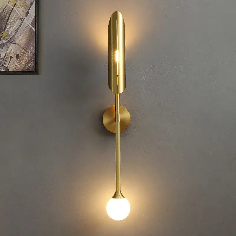 Modern golden metal led wall lamps with sleek elongated design and spherical bulb for bedroom and living room decorbites decor
