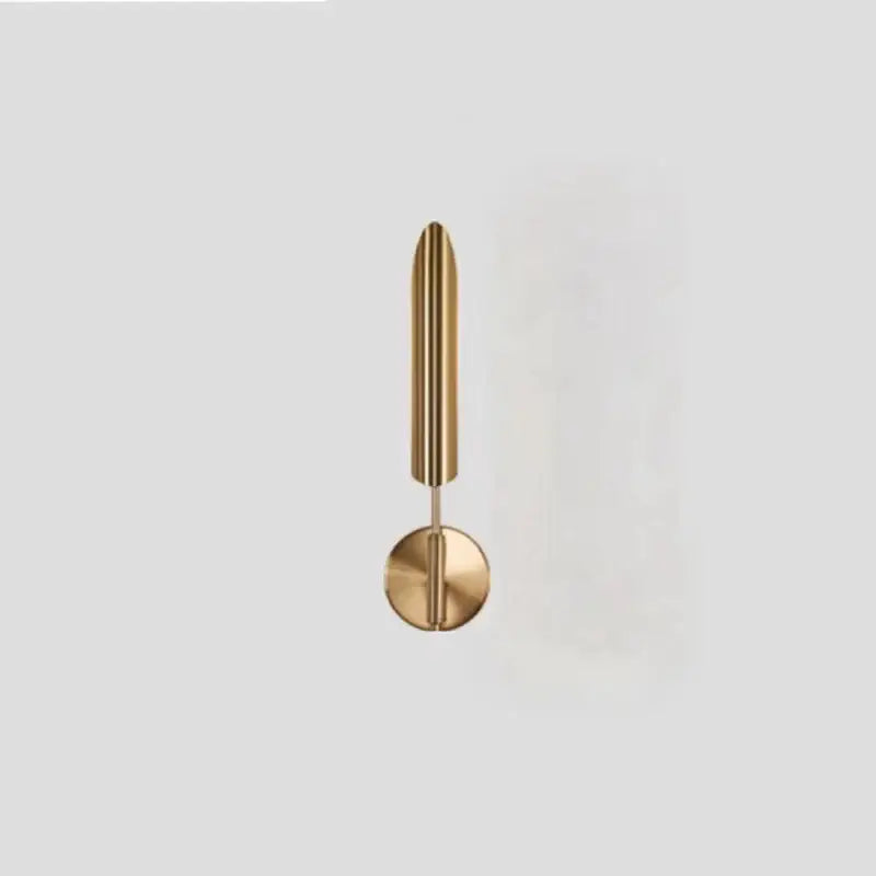 A modern golden metal led wall lamp with polished brass finish and slender vertical rod design for bedroom decorbites decor