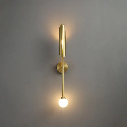 Modern golden metal led wall lamps with sleek elongated design featuring cylindrical upper element and spherical bulb base for decorbites golden metal decor