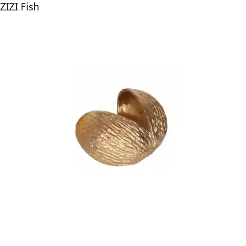 Modern golden nut shell ornaments desk decor featuring a textured glossy golden nut shell by decorbites