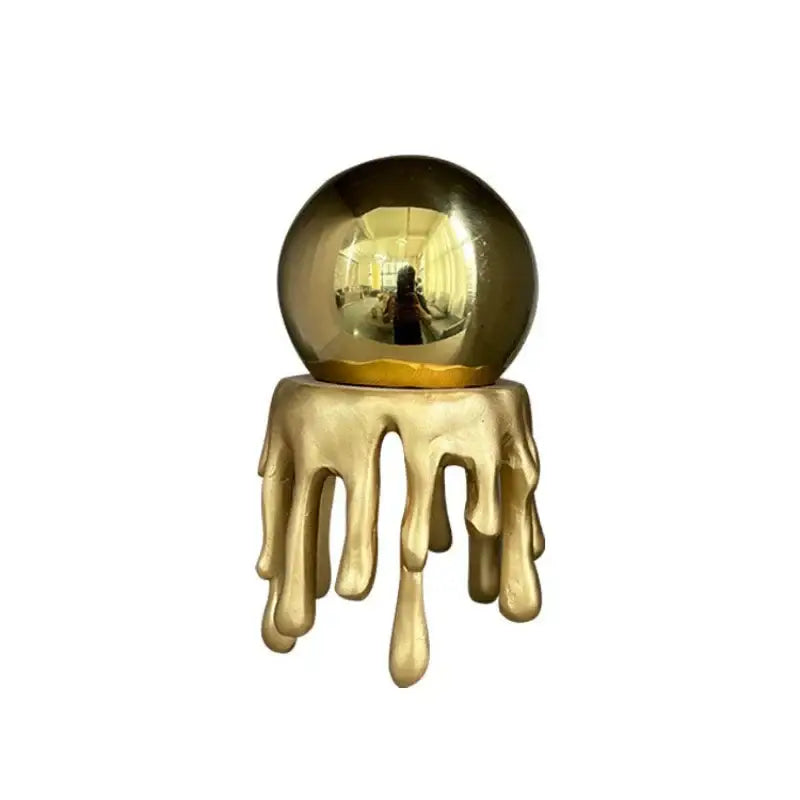Modern golden octopus spherical ornament featuring a golden reflective crystal ball with dripping gold resin decorbites golden octopus