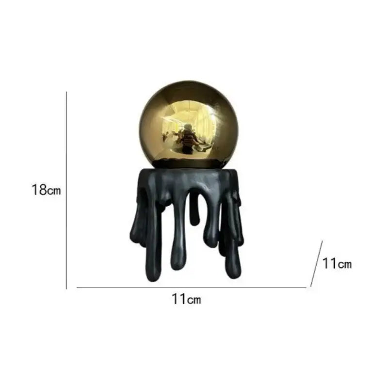 Shiny golden octopus spherical ornament with black dripping resin base for modern living room decor by decorbites
