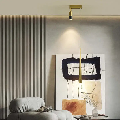 Modern golden pendant chandelier with gold-toned minimalist cylindrical light and black accent by decorbites golden pendant