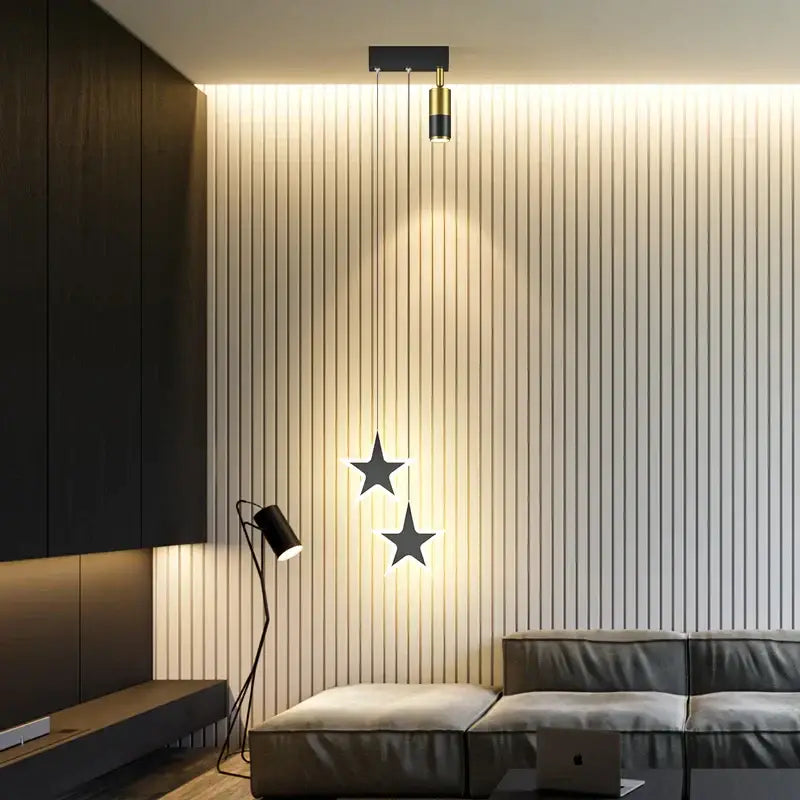 Modern golden pendant chandelier with black star-shaped lights and gold accents from decorbites golden pendant collection