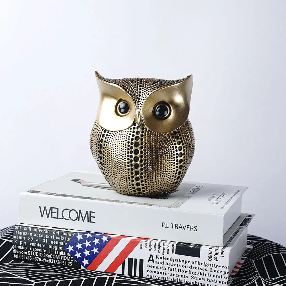 Modern golden perforated owl figurine with glossy black eyes by decorbites for living room animal statues decor