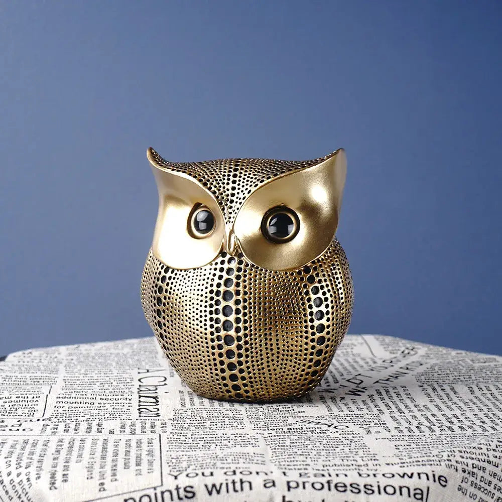Modern golden perforated owl figurine with textured surface and black eyes ideal as decorbites animal statues for living room
