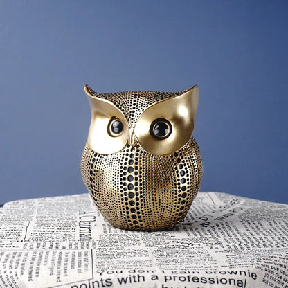Modern golden perforated owl figurine with textured surface and black eyes ideal as decorbites animal statues for living room