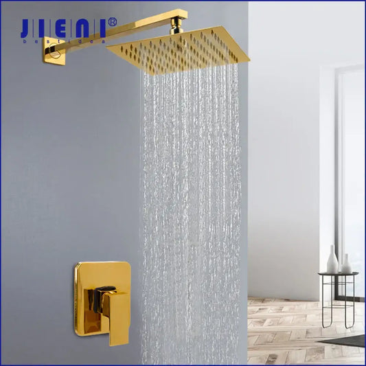 Modern golden plated rainfall shower system with gold-colored square shower head and matching wall-mounted control valve